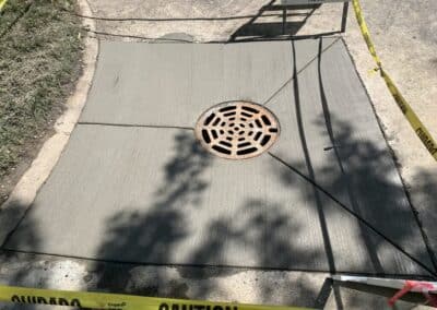 Catch basin installation with concrete sidewalk patch and drain cover