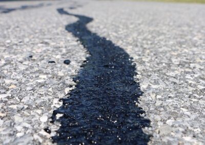 Close-up of a filled crack in a road surface