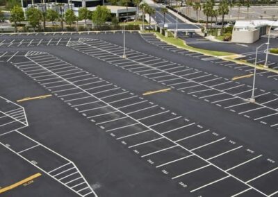 Parking lot with white-lined spaces and light poles