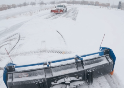 Snow removal from a commercial parking lot during winter conditions